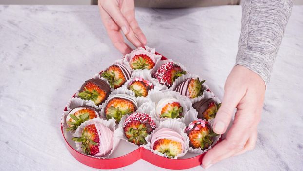 Step by step. Heart-shaped box with chocolate dipped strawberries.