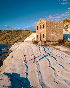 Punta Bianca Sicily Agrigento, white cliffs coast with an abandoned house in Sicilia Italy, couple men and women on vacation in Sicily Italy