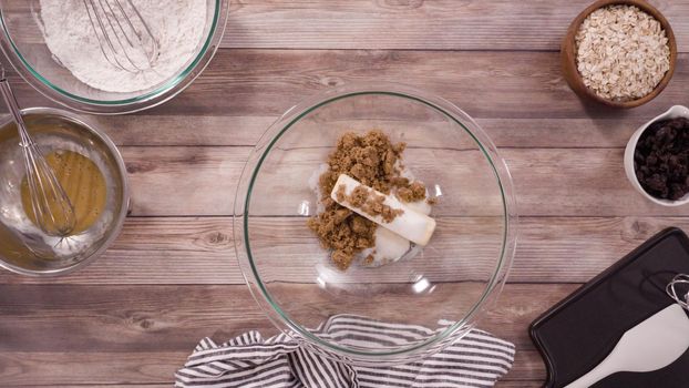 Flat lay. Step by step. Mixing ingredients to bake oatmeal raising cookies in a glass mixing bowl.