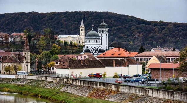 Ancient Sighisoara in Romania, panoramic old clock tower and medieval architecture view. Cityscape on historic european town with Dracula house and nature