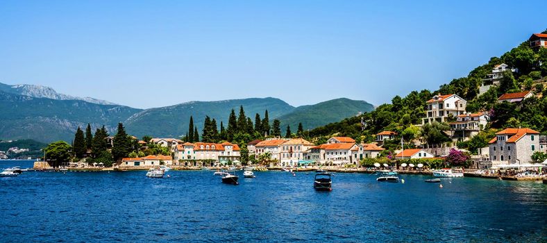 Scenic Mediterranean city Perast in Montenegro in Kotor bay, view from Adriatic sea. Beautiful architecture with mountains on background