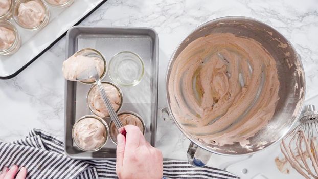 Flat lay. Step by step. Scooping homemade chocolate ice cream into glass jars.