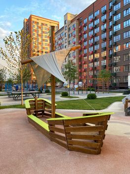 Colorful children's playgrounds in the courtyard of a residential building. Safe modern playground. Arrangement of the courtyard of a new building.