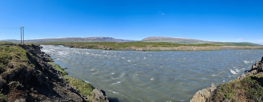 Fantastic landscape with flowing rivers and streams with rocks and grass in Iceland 