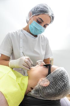 Dentist Examining Patient's Mouth with dental mirror In Clinic. Checkup concept