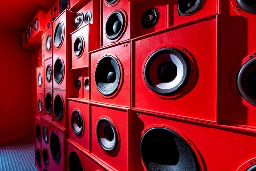 Photo of close up wall with red audio speakers background.