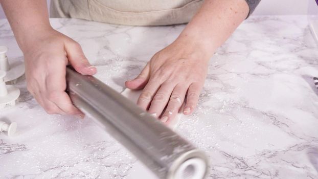 Step by step. Rolling our white fondant on a marble counter.