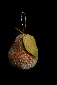 Pear. Fur-tree toy isolated on a black background. High quality photo