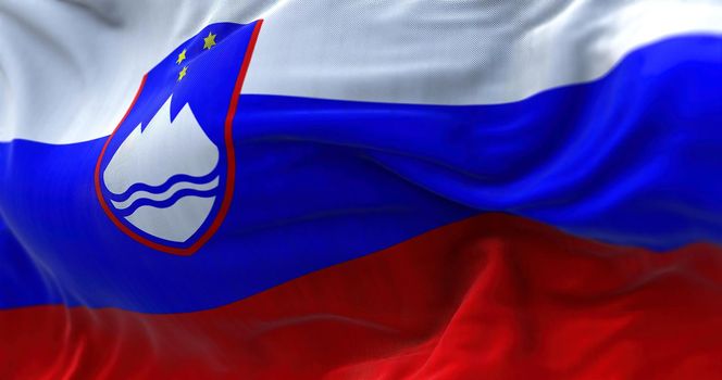 Close-up view of the Slovenia national flag waving in the wind. Slovenia is a country in Central Europe. Fabric textured background. Selective focus