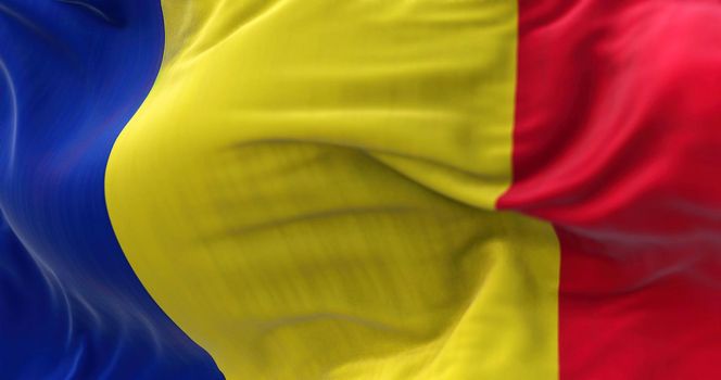 Close-up view of the Romania national flag waving in the wind. Romania is a country located at the crossroads of Central, Eastern, and Southeastern Europe. Fabric textured background. Selective focus
