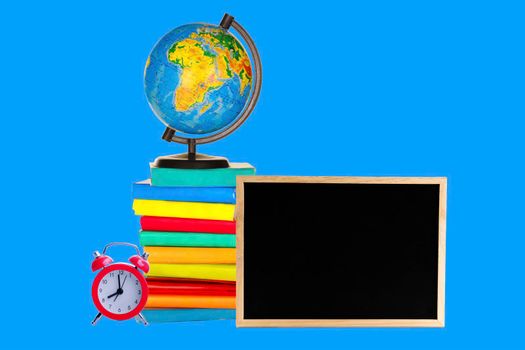 Books, a globe, a clock and a blackboard on a blue background. Back to school concept Space for text