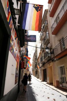 Benidorm, Alicante, Spain- September 11, 2022: Streets and facades adorned with colorful rainbow and bear flags for The Gay Pride in Benidorm