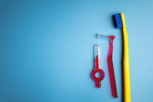 Dental hygiene. Toothbrush, hygienic brushes on a blue background. flat top view.