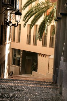 Benidorm, Alicante, Spain- September 9, 2022: Narrow cobbled street with vintage street light in Benidorm