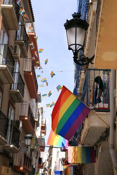 Benidorm, Alicante, Spain- September 11, 2022: Streets and facades adorned with colorful rainbow flags for The Gay Pride in Benidorm