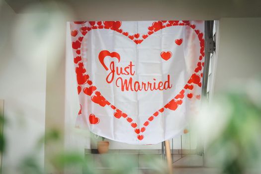A heart-shaped papers with Just Married text in the middle