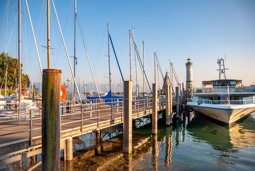 A picturesque view of ships docked at the Lindau Harbor on the Bodensee lake in Germany