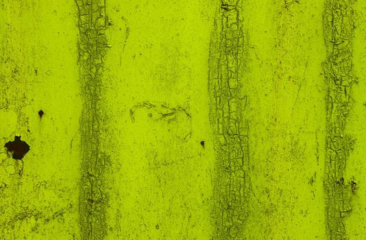 A surface of old green damaged mold-covered paint. Abstract Background of peeling, cracked paint.