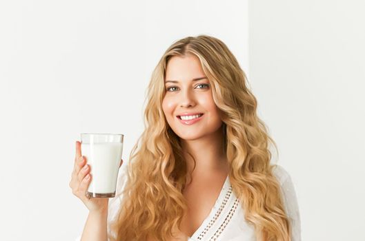 Diet, health and wellness concept, woman holding glass of milk or protein shake cocktail