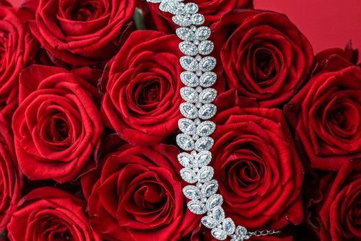 Gemstone jewellery, wedding fashion and luxe shopping concept - Luxury diamond bracelet and bouquet of red roses, jewelry love gift on Valentines Day and romantic holidays present