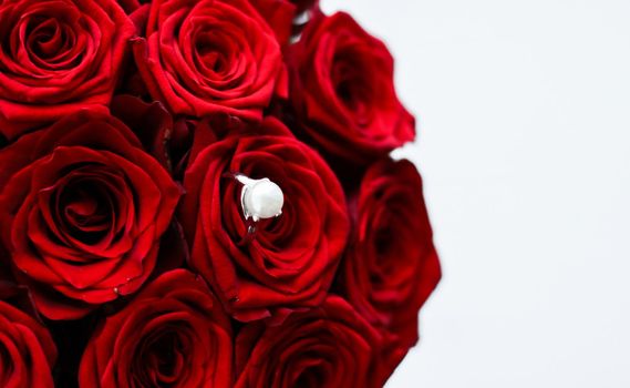 Gemstone jewellery, wedding present and engagement proposal concept - Beautiful white gold pearl ring and bouquet of red roses, luxury jewelry love gift on Valentines Day and romantic holidays