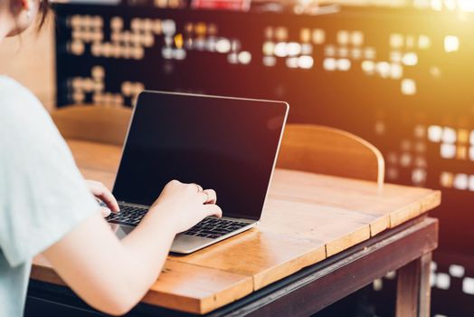 Business young women lifestyle freelance working using laptop computer, Female student doing homework on laptop in an outdoor modern loft cafe