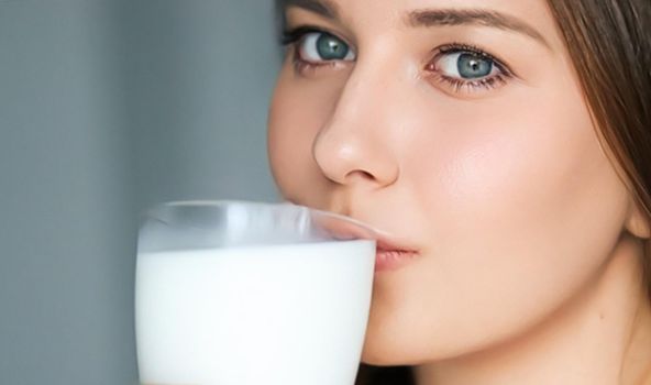 Diet and wellness, young woman drinking milk or protein shake cocktail, portrait