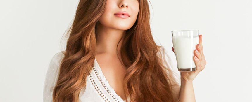 Diet, health and wellness concept, woman holding glass of milk or protein shake cocktail