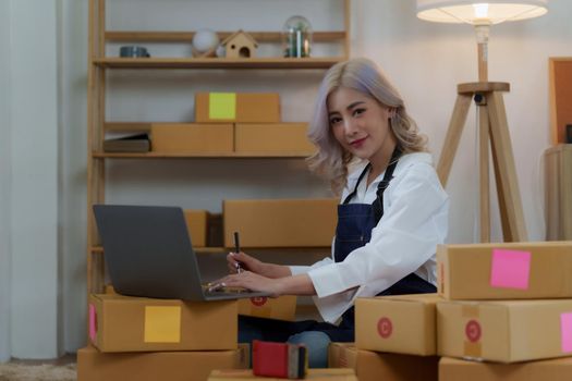 Asian SME business woman working at home office. online shopping concept