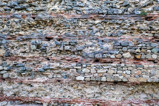 The surface of an old stone wall, perfect for the background. 