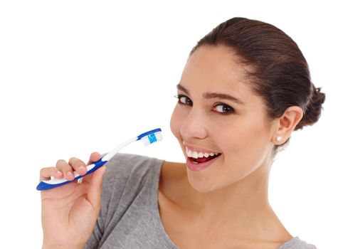 Regular cleaning for strong teeth and gums. A young woman brushing her teeth