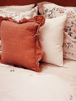 Vintage countryside style bedding with floral pattern on wooden bed in bedroom, interior design detail