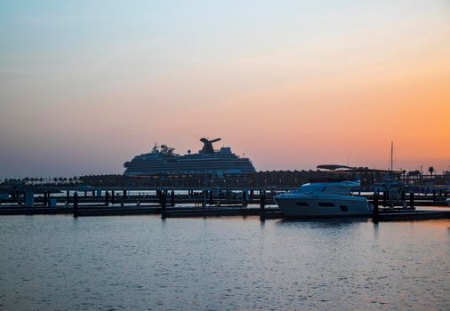 Dubai, UAE - 07.19.2021 Sunset in Dubai harbor. Cruise ship on background