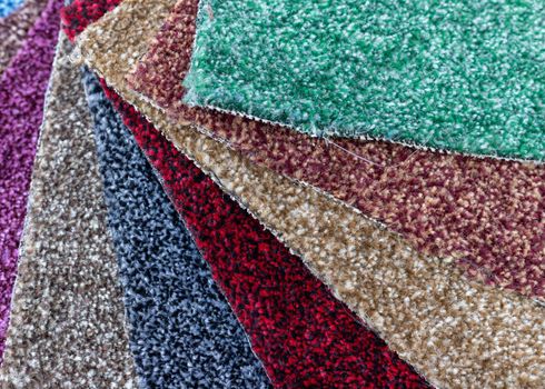 some colorful carpet pieces neatly arranged as a colorful texture background