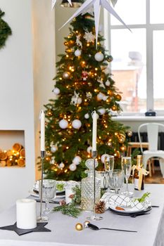 Light festive Christmas interior, set table for a festive dinner.