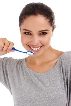 Staying healthy through good dental hygiene. A young woman brushing her teeth