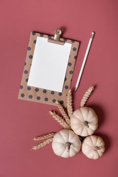 Blank tablet for text next to decorative pumpkins and ears of wheat. Autumn theme mockup.