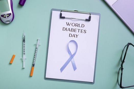 World Diabetes Day text with blue ribbon and glucometer, medical supplies on color background top view.