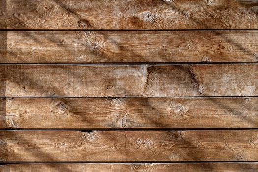 Wooden, vintage background with beautiful shadows and sunbeams. Unusual lighting, clear wood structure. Template for copy space your product or design.