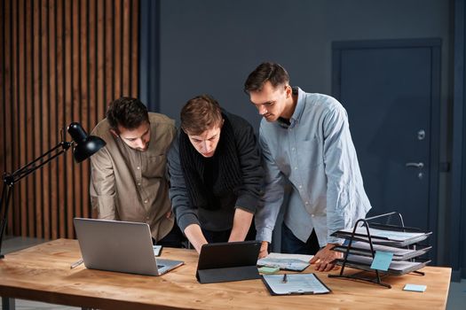 business team working on a new project in a night office. concept of overtime work.