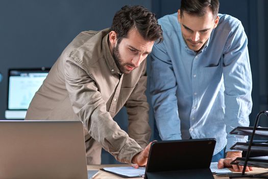 business colleagues using a digital tablet while working on a new project. close-up.