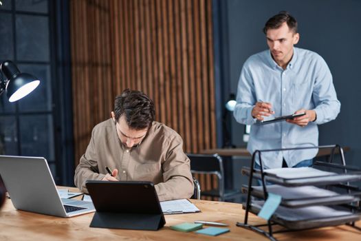 employees working with documents until late at night. concept of overtime work.