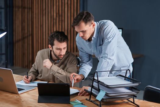 young businessmen working in the office together at night . concept of overtime work.