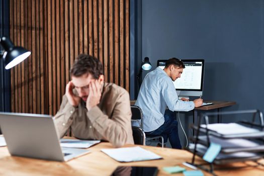 tired businessman working with documents late at night . concept of overtime work.