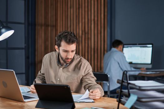 employees working in the office until late at night. concept of overtime work.