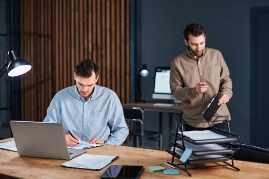 young colleagues working in the office late at night . concept of overtime work.