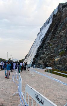 Sharjah, UAE - 07.20.2021 - Visitors at Sharjah amphitheatre waterfall, Khor Fakkan area.