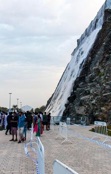 Sharjah, UAE - 07.20.2021 - Visitors at Sharjah amphitheatre waterfall, Khor Fakkan area.