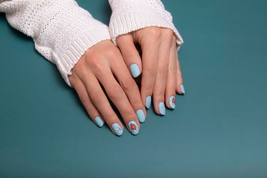 Winter blue manicure gel polish with stickers under a matte top.