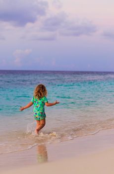 Little girl walking on the beach
